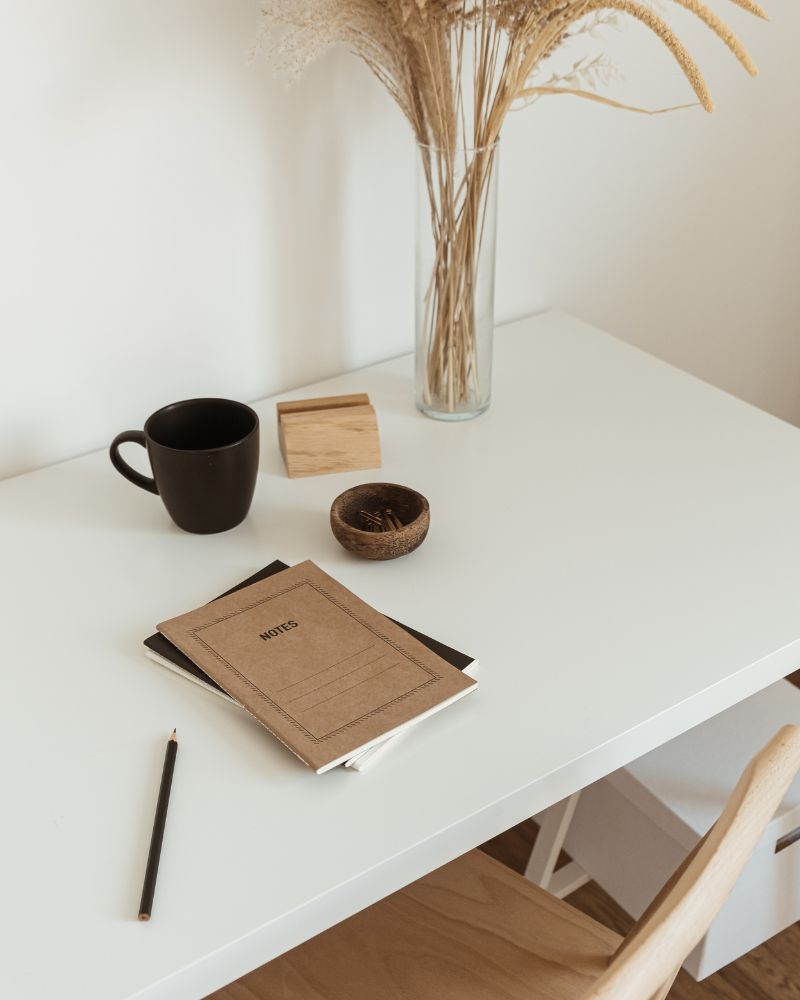 Bureau minimaliste avec carnets et une tasse